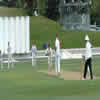 Matthew Bell pushes a delivery down the ground while Warren Wisneski and Brendon McCullum look on