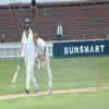 Chris Martin bowling with Matthem Bell beside him and Chris Cairns in the background